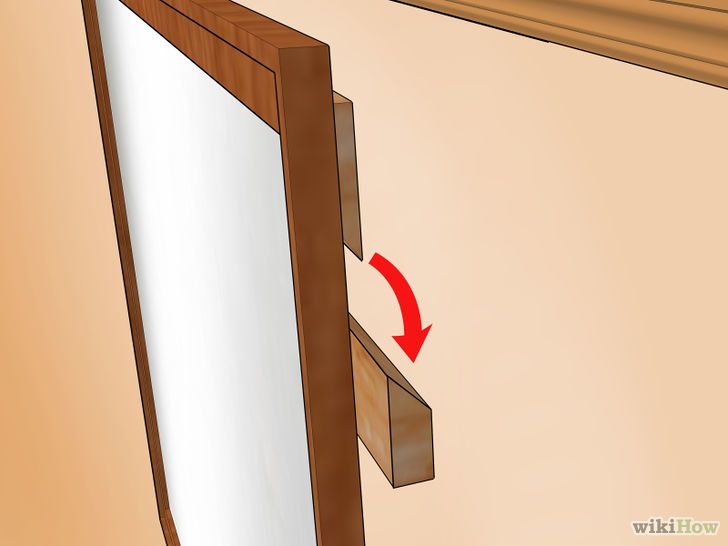 Comment fixer un grand miroir au mur sans percer